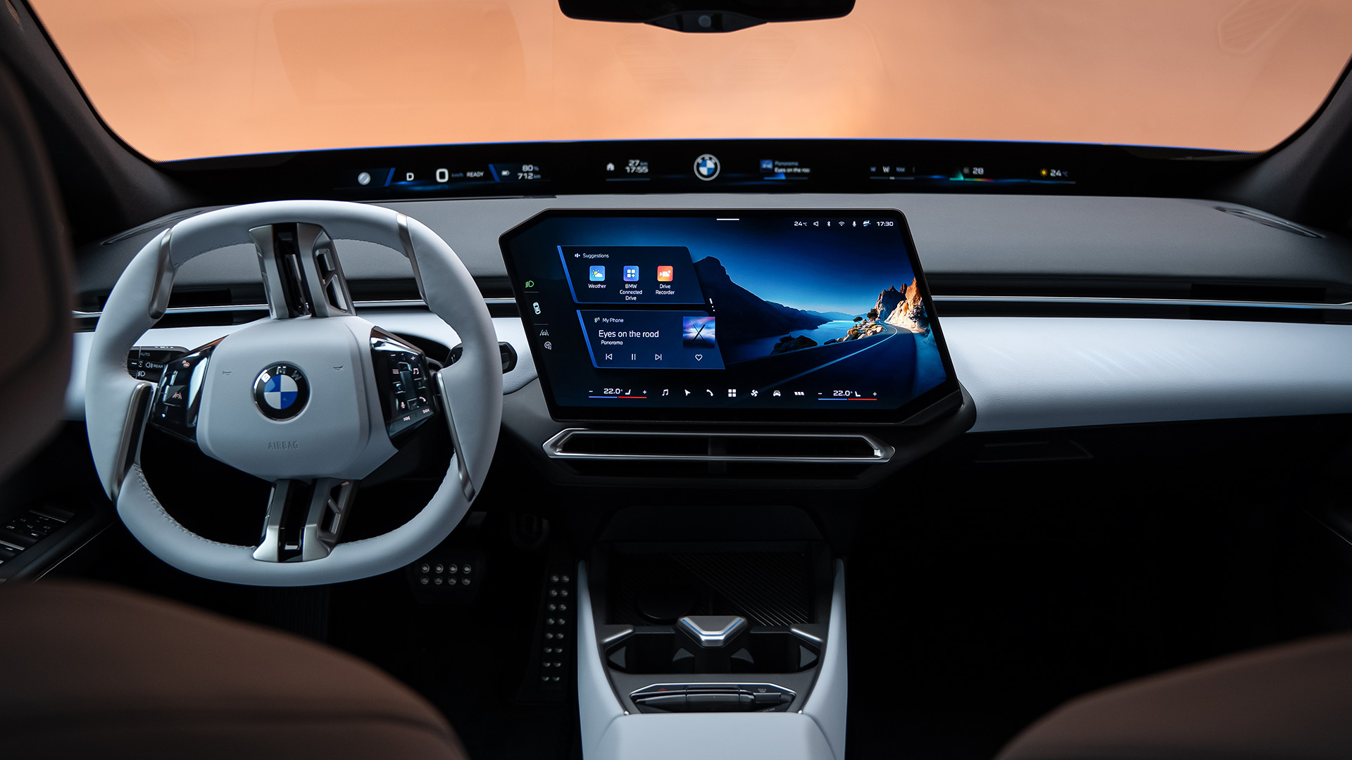 BMW i3 Saloon interior featuring BMW Operating System X and a central touchscreen viewed from the rear seats.