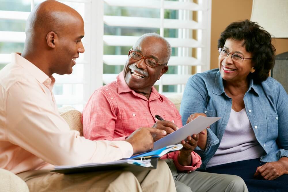 A financial advisor explains a document to a senior couple