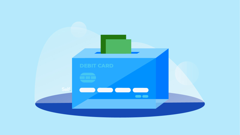 Paying cash into a prepaid debit card, shaped like a box. 