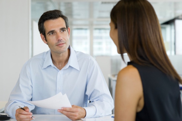 An image of a man and woman at a job interview in an office setting.