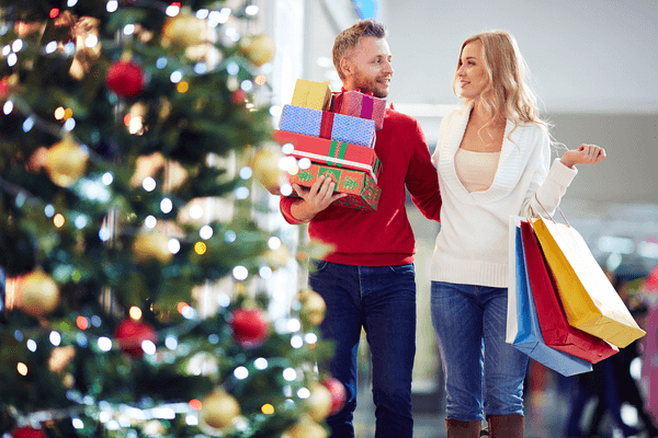 man and woman shopping together for holiday gifts
