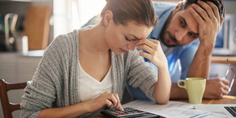 Woman has a headache from her finances. 