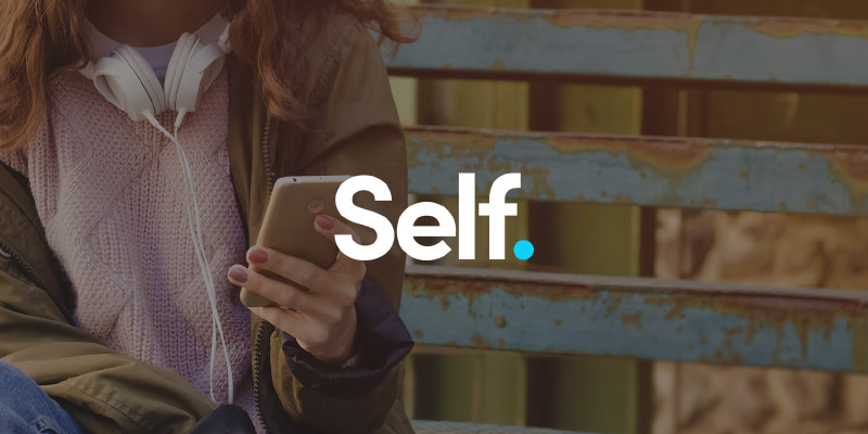 self logo on backdrop of young woman holding phone with headphones