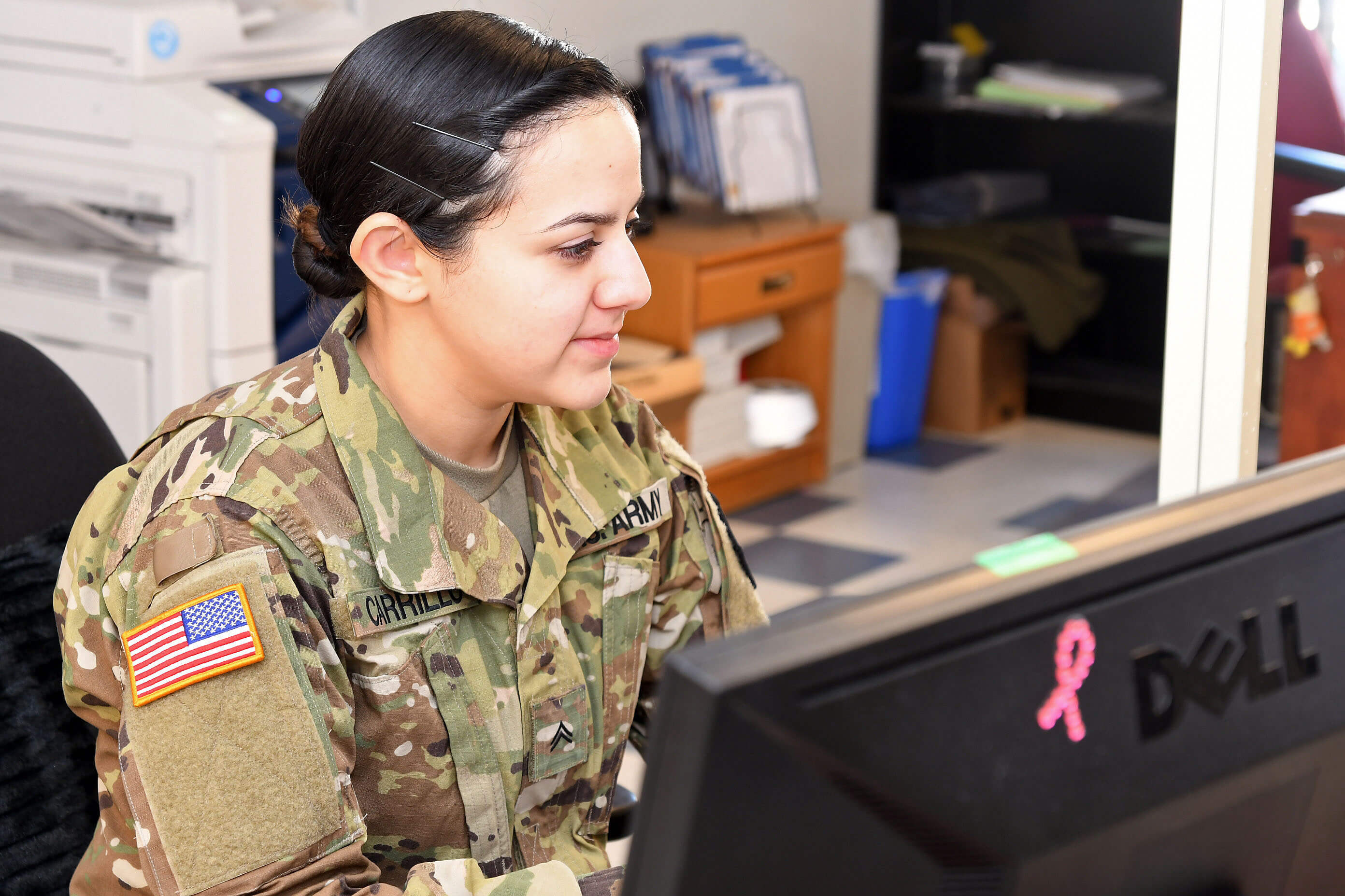 An images of a Servicemember working at her computer
