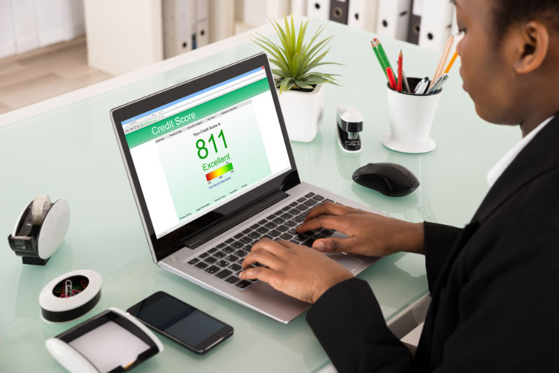 Woman looking at credit score at computer