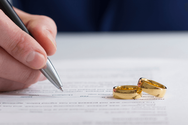 Two rings on a set of divorce papers