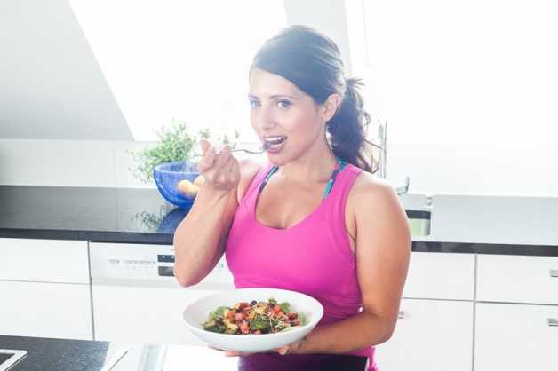 Alice eating a salad in kitchen