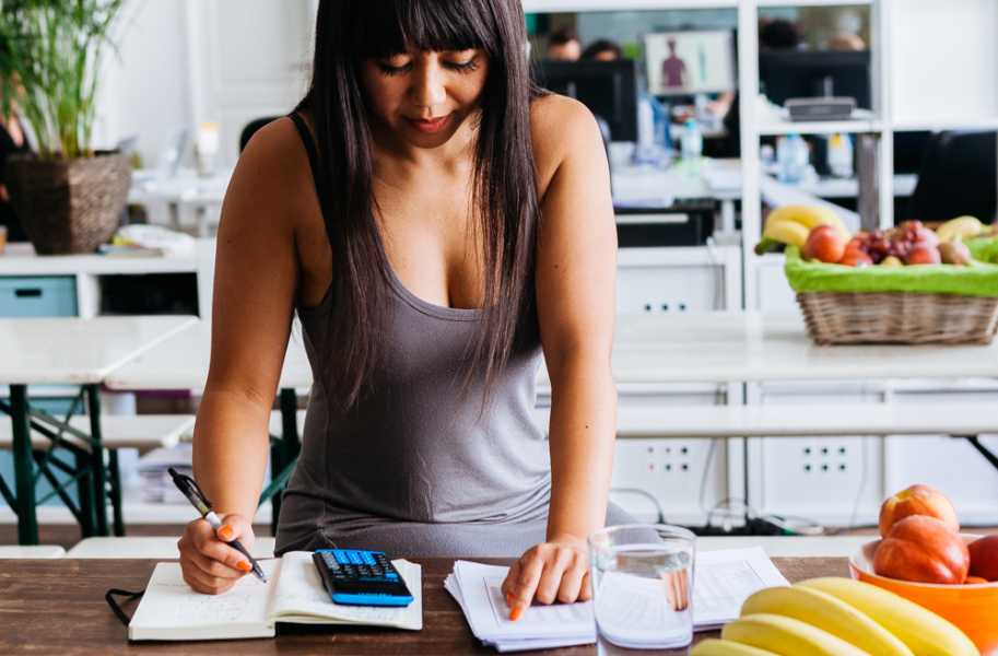 Marfie on kitchen counter with calculator and pen