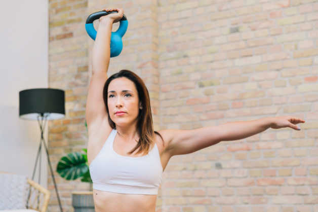 female with kettle bell indoors