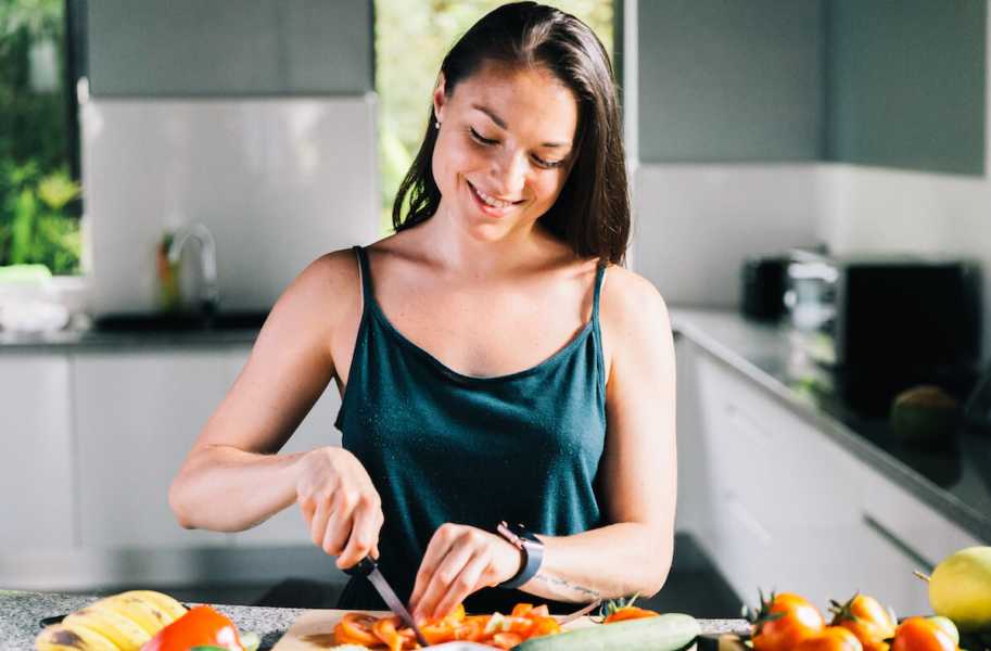 Emily slicing vegetables in a kitchen