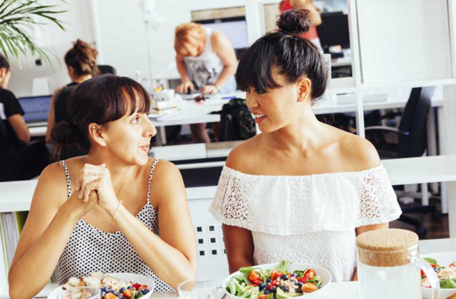 Coach Marife and woman sitting at table with food