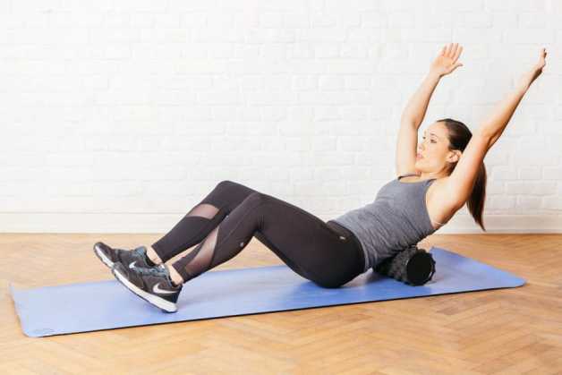 Alba using the foam roller on back 