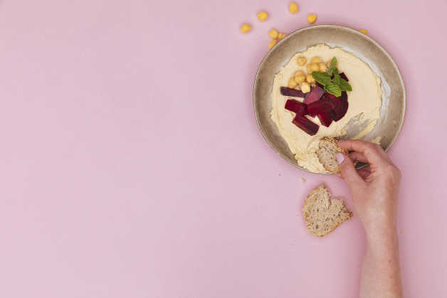 hummus with beetroot in a bowl with bread