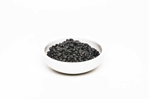 Black beans, uncooked in white bowl