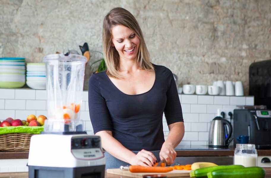 Coach Lisa chopping a carrot happily 