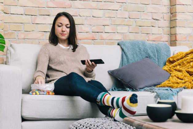 Emily on the couch with candy and rainbow socks