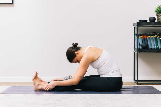 Fitness Female forward fold indoor yoga
