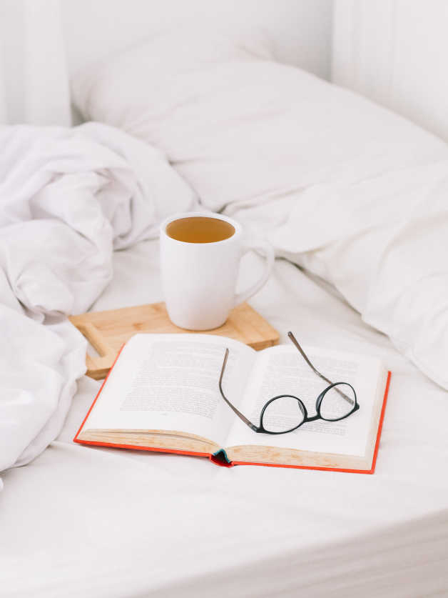 bed book tea glasses