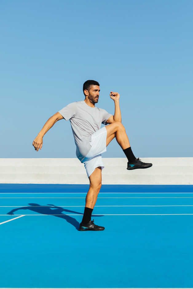 Male exercising outdoors blue background
