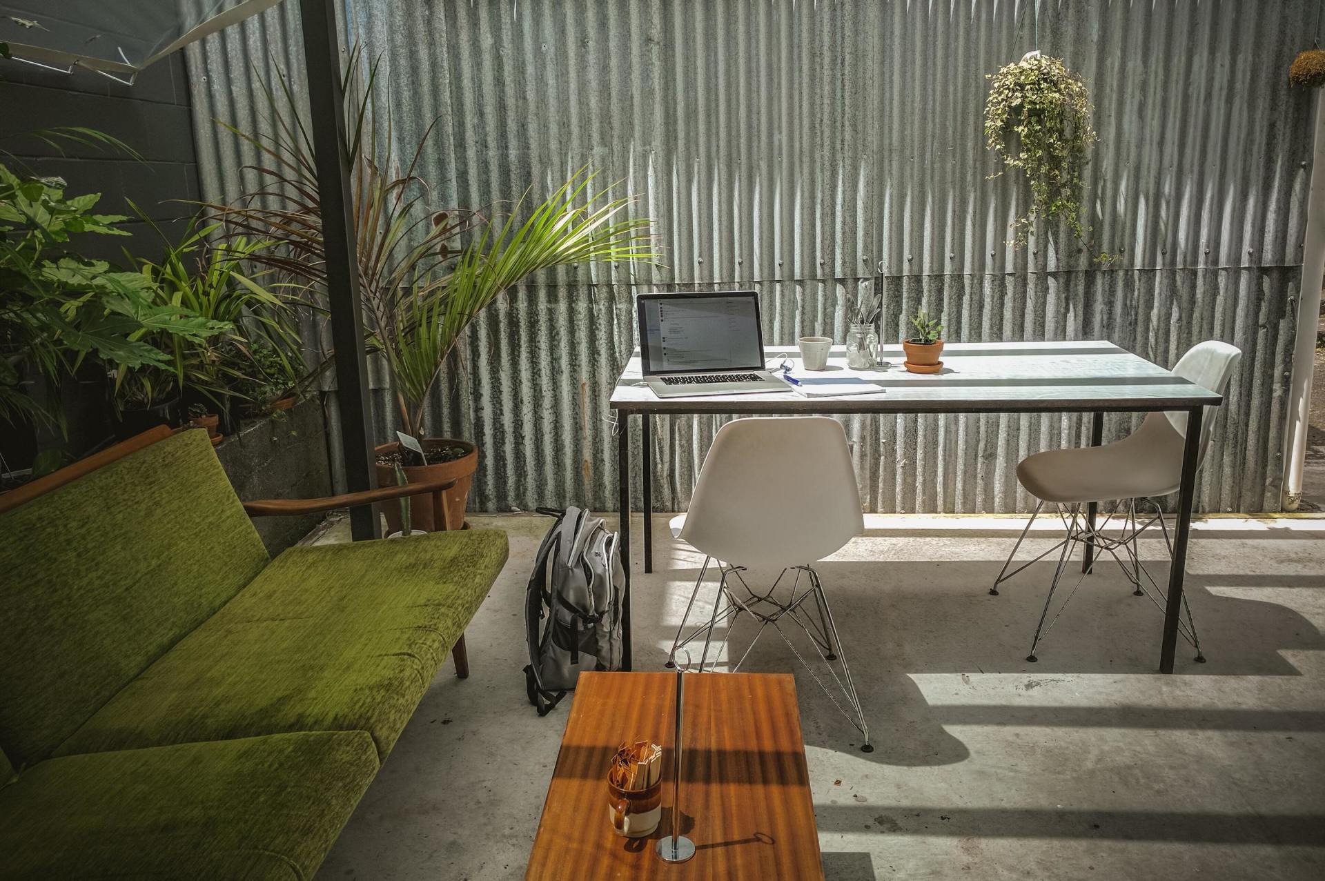 outdoor home office with desk, chairs and sofa