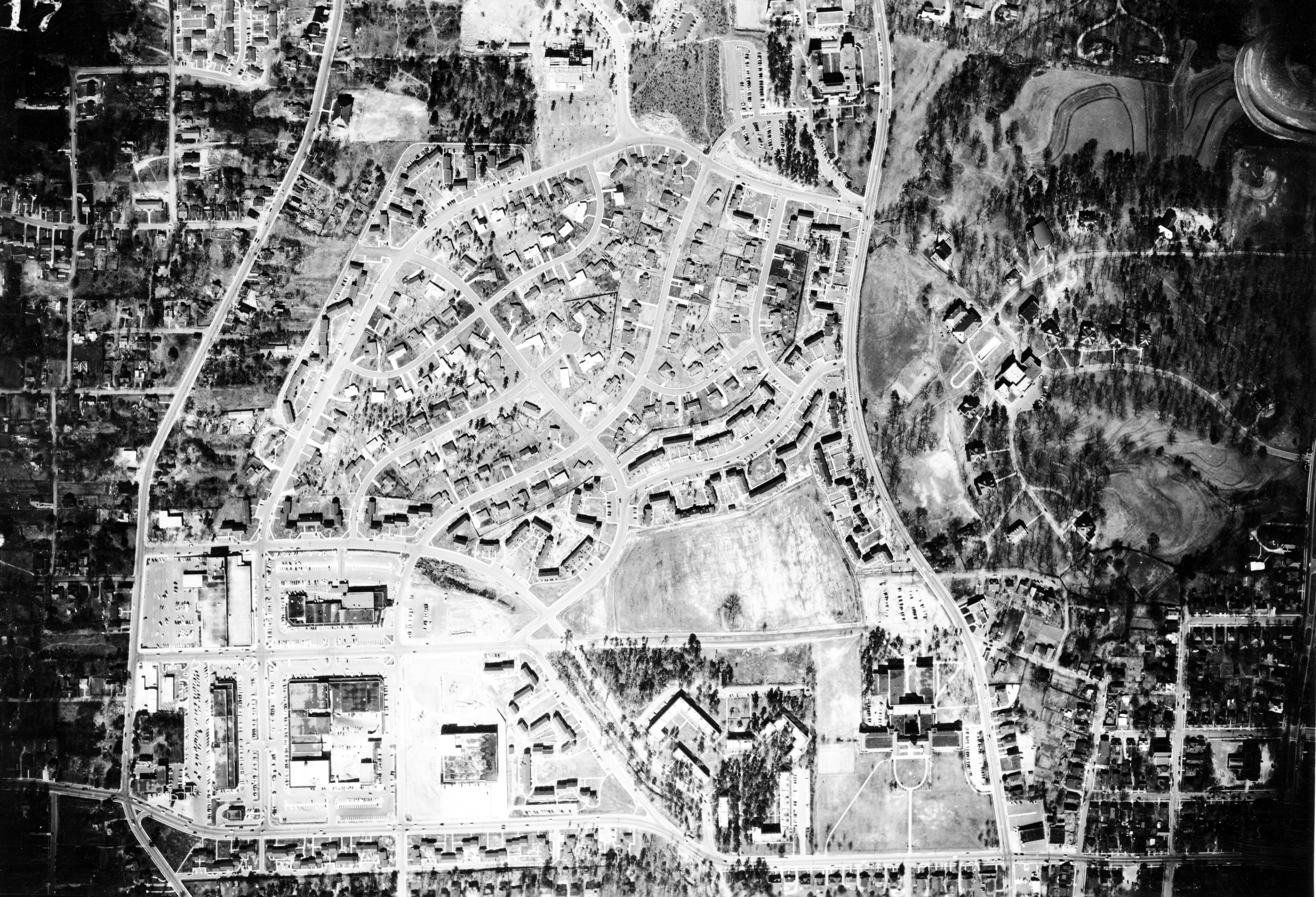 This aerial photo of Raleigh, N.C. from 1955 shows Cameron Village. Oberlin Road runs along the left side of frame, and Clarke Avenue runs along the bottom. Today, the area is booming with shops and promenades. (Credit: Conservation and Development Photog