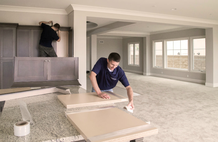 The Renovation Angel team removing a new-never-used kitchen from a luxury home in Irvine, CA. Recycled kitchens provide an upgrade with more character, and often higher-end appliances, at a fraction of the cost. (Courtesy of Renovation Angel)