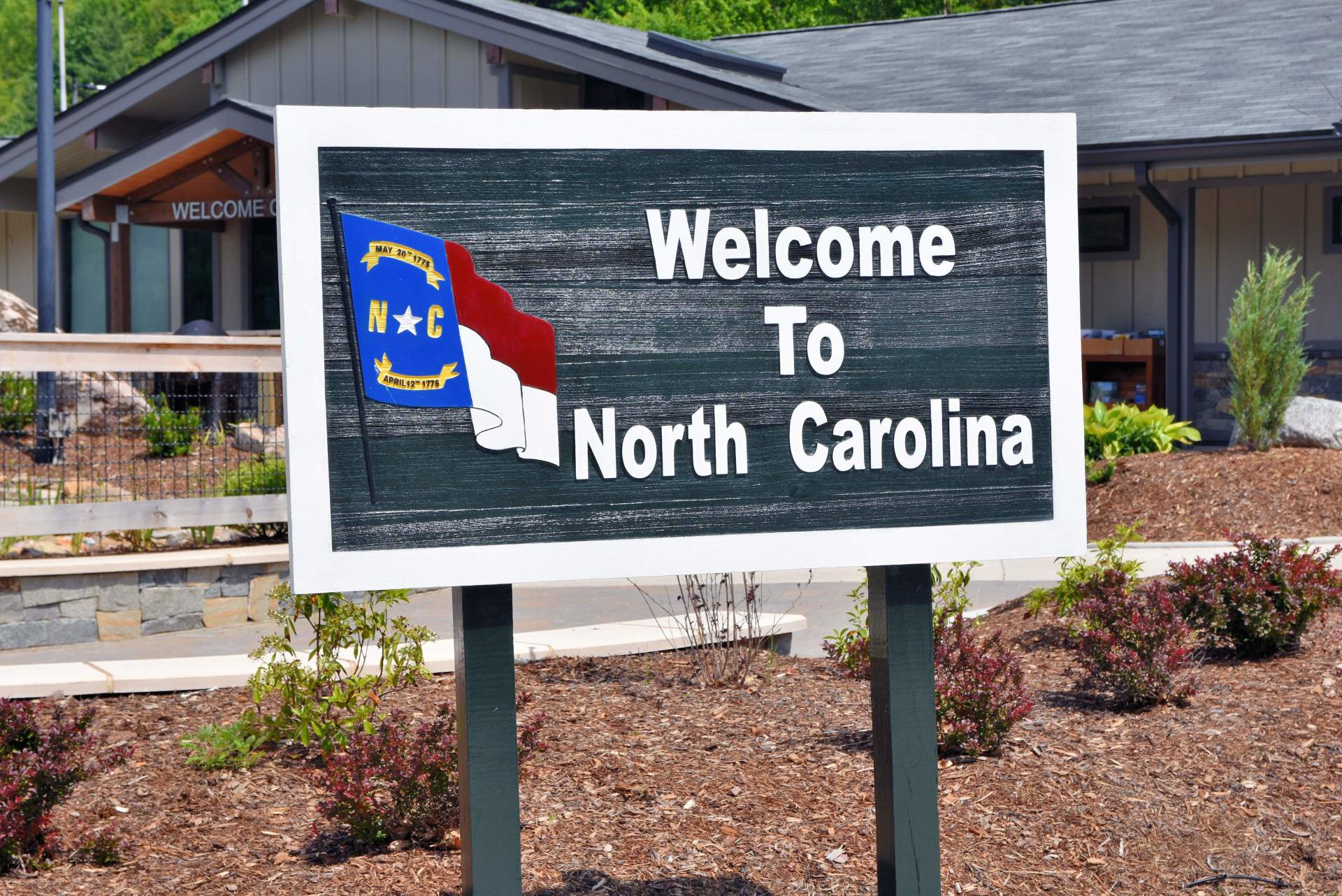 Charlotte, North Carolina's real estate is booming-- and investors still have a chance to enter the market. Charlotte offers many excellent amenities, and is centrally situated in North Carolina. This sign in Clyde, N.C. taken inJune 2020 welcomes those e