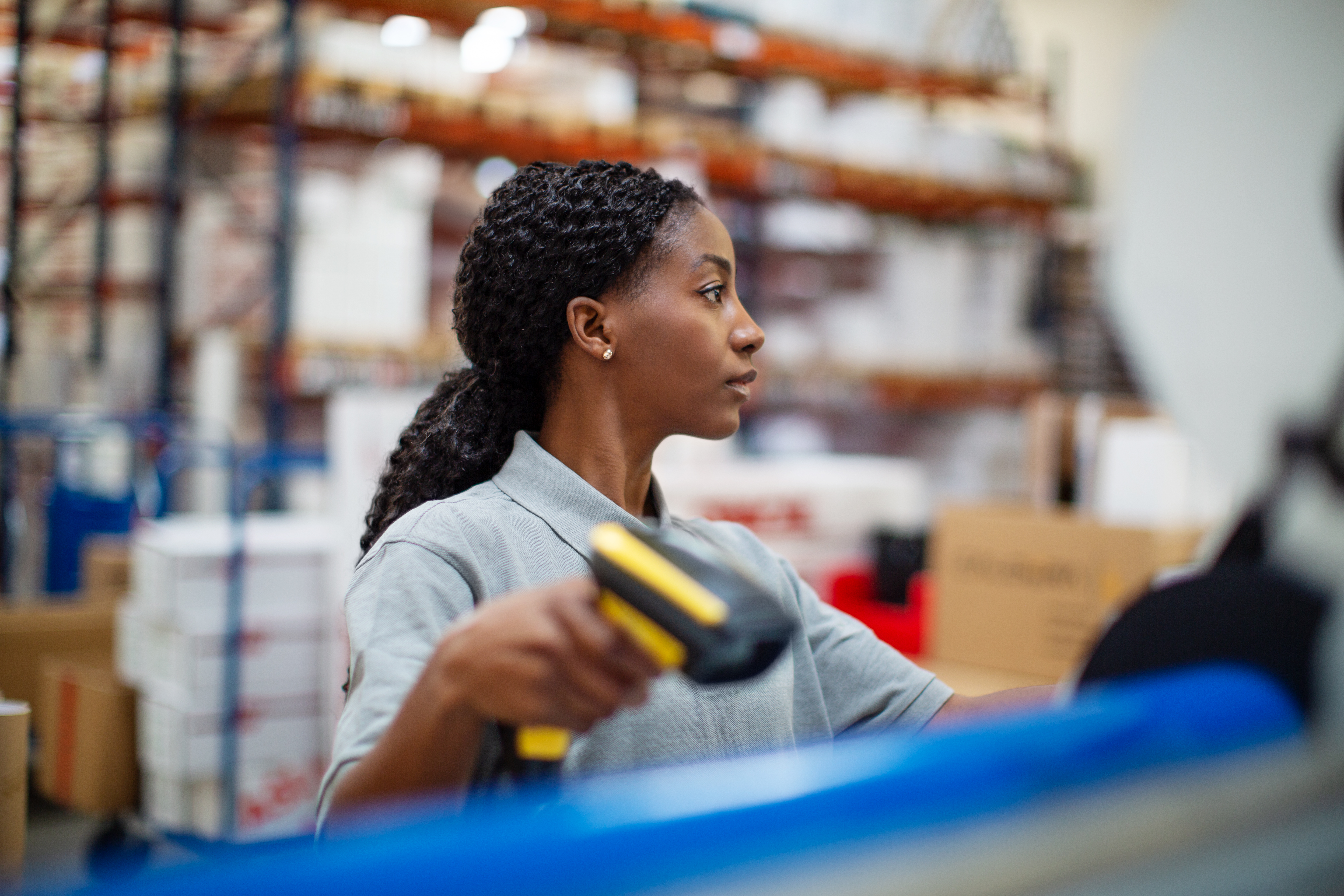 Warehouse worker scanning inventory with a handheld barcode scanner