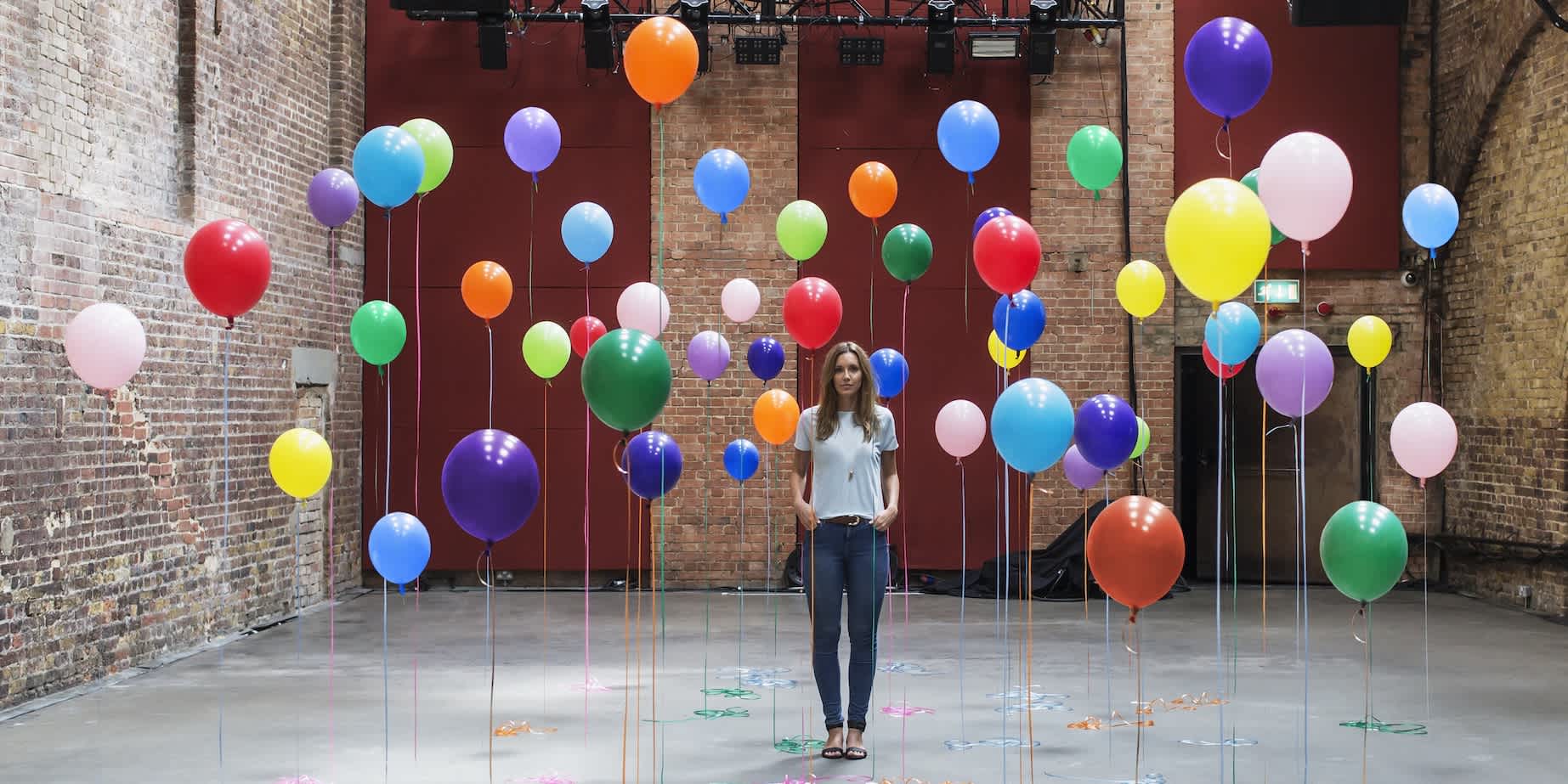 A warehouse filled with floating balloons, indicating inflation and choice.