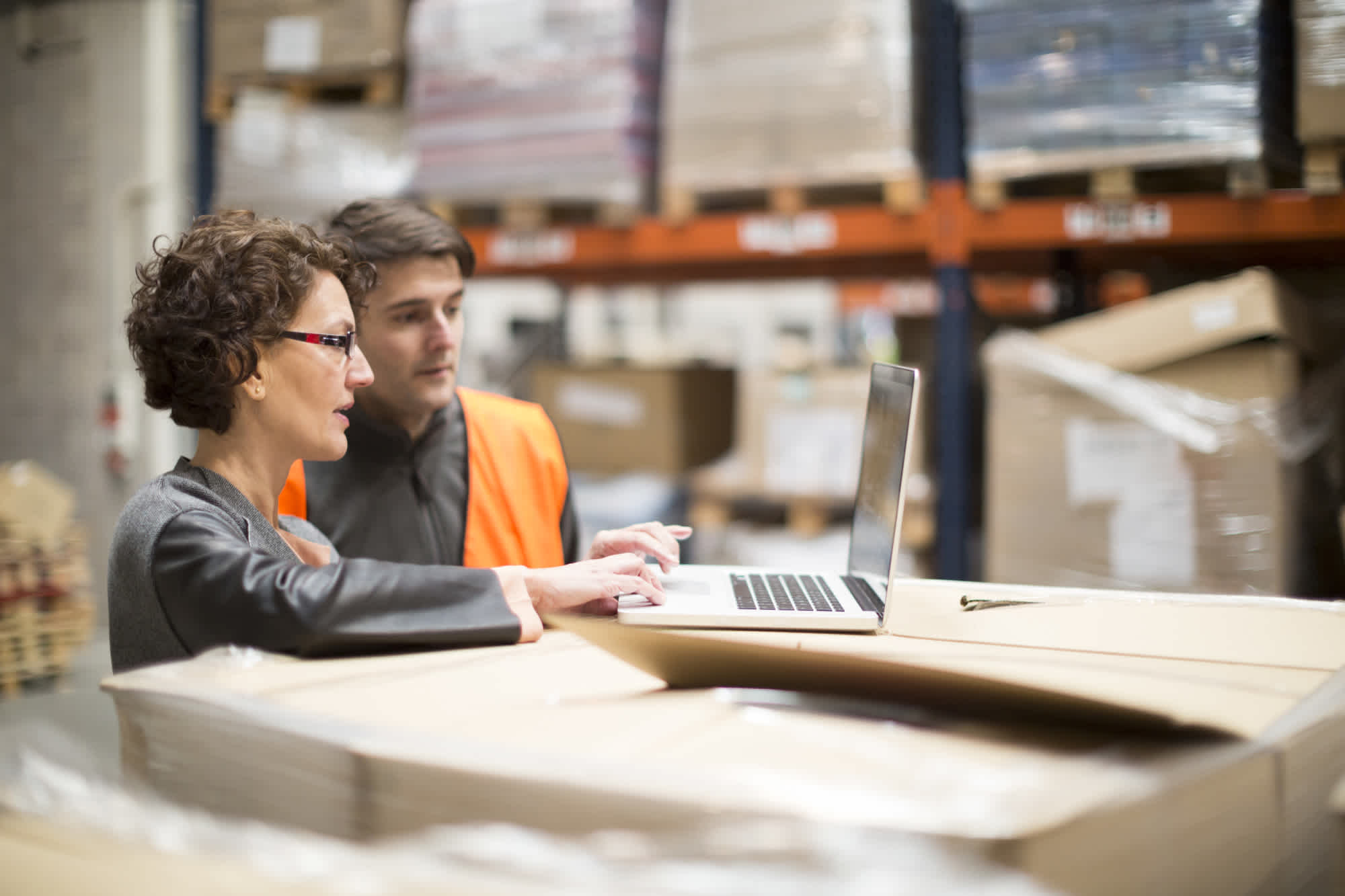 Employees in a warehouse on a laptop