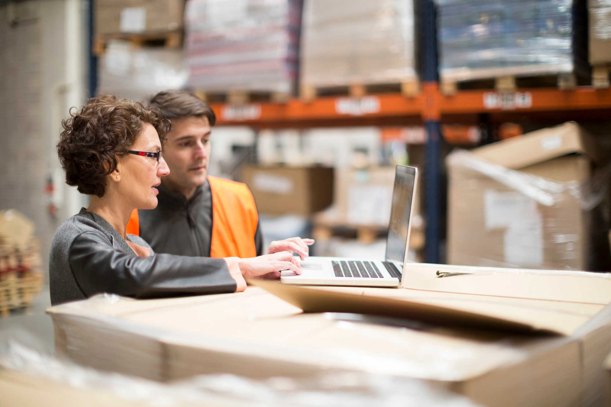 Employees in a warehouse on a laptop