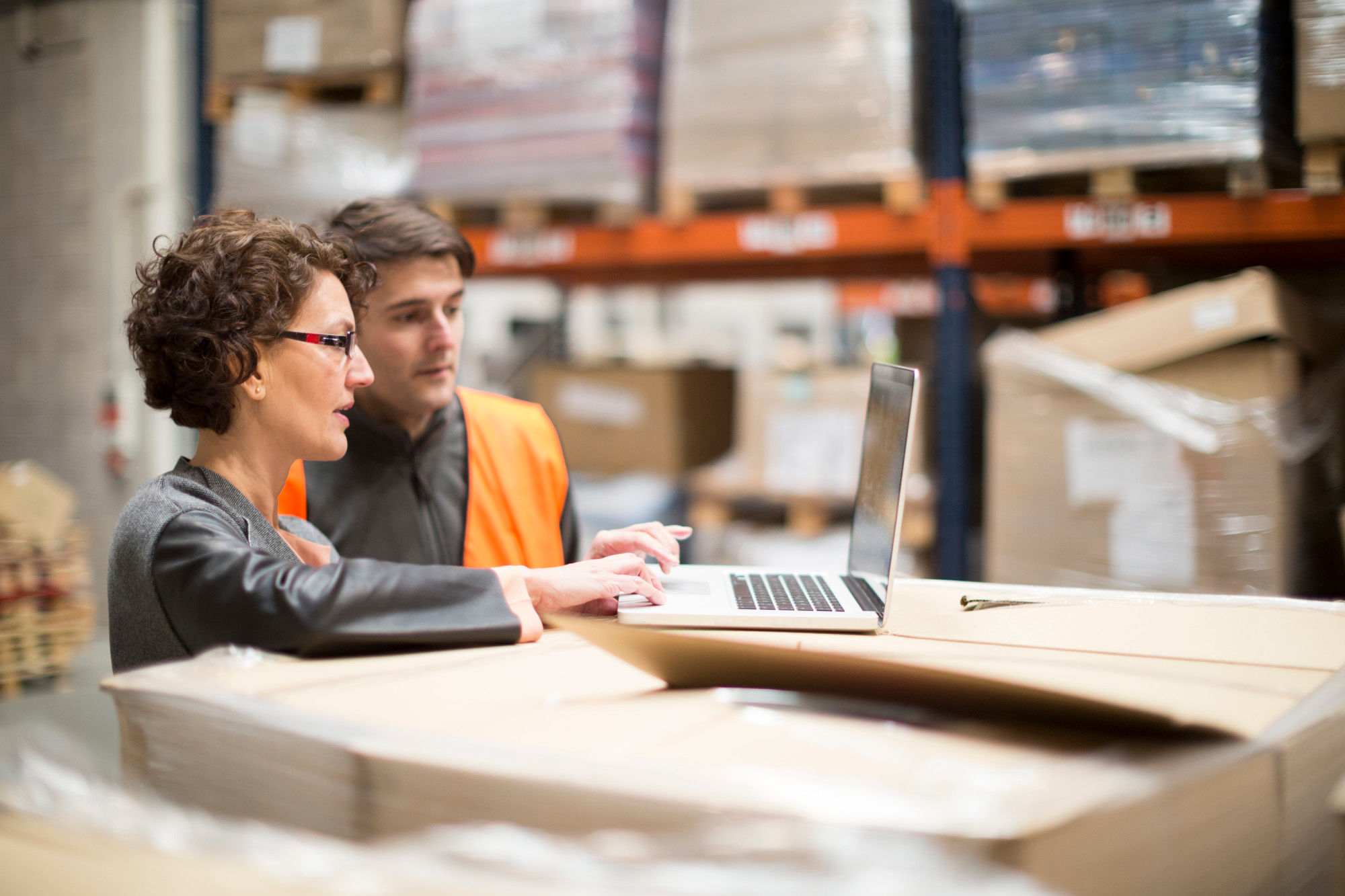 Employees in a warehouse on a laptop