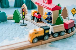 Wooden toy train set with colorful signs, trees, and tracks