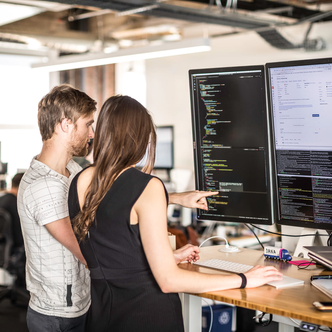 Two people looking at a computer screen