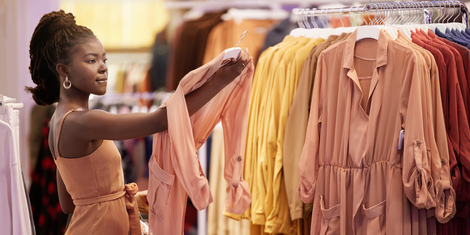 woman with rack of clothes GettyImages 1600x800