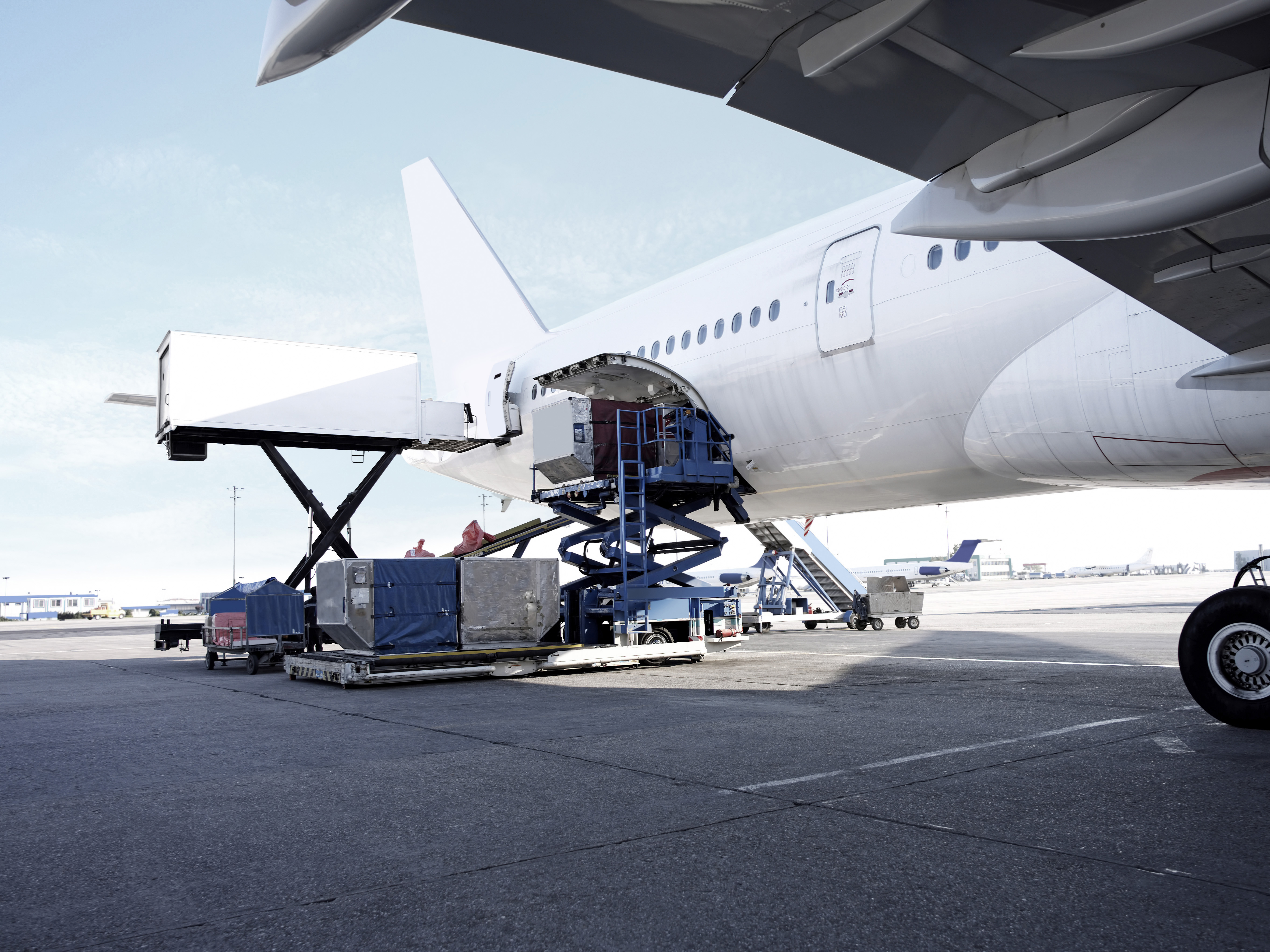 Cargo being loaded into the hold of a commercial aircraft on the tarmac