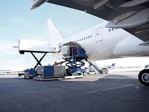 Cargo being loaded into the hold of a commercial aircraft on the tarmac