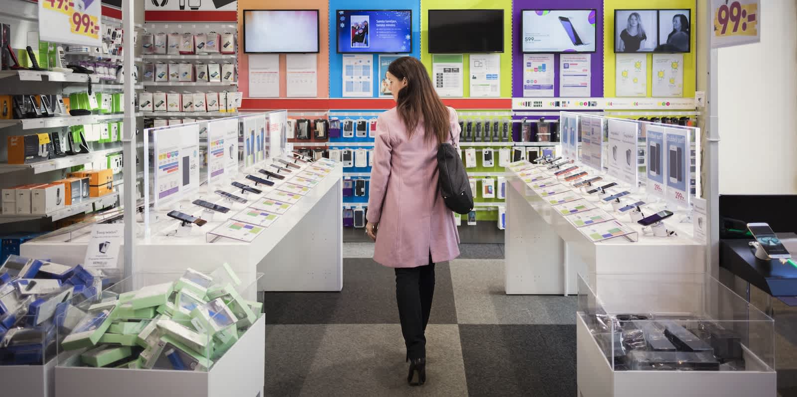 A shopper looks at a selection of electronics goods