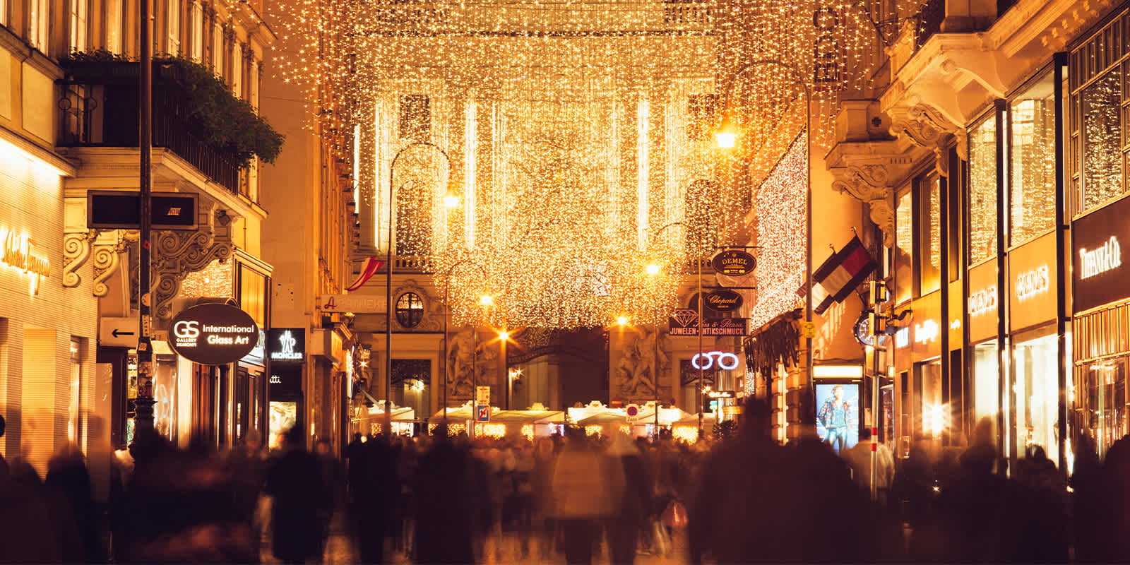 Holiday lights over crowds shopping