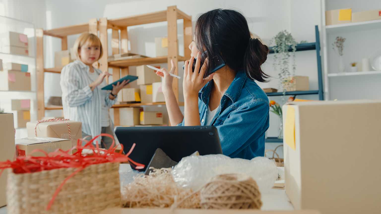Two small business owners taking inventory in their office