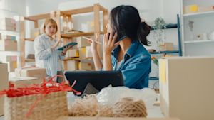 Two small business owners taking inventory in their office