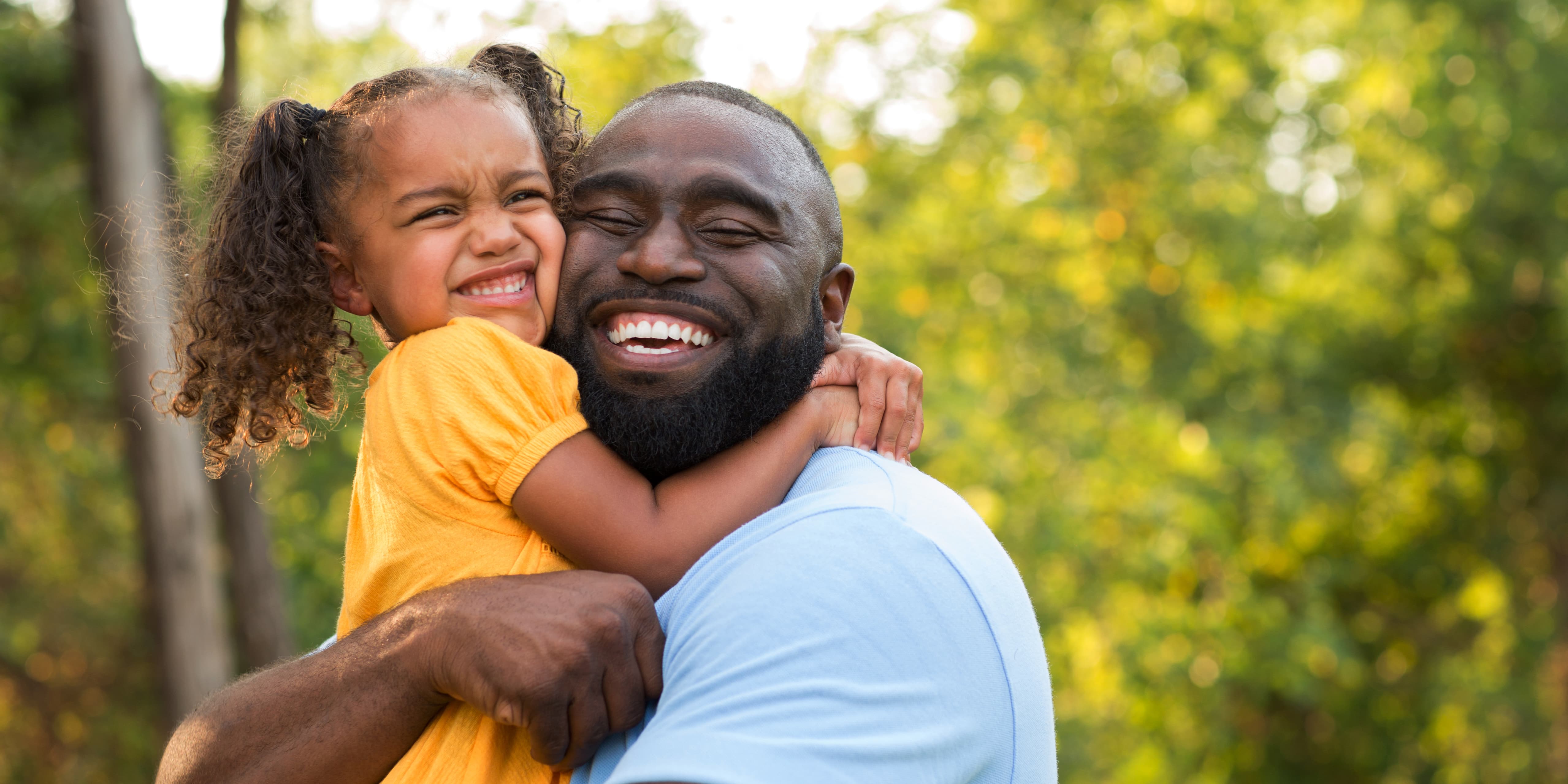 Father and daughter smiling