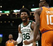 Dec 31, 2021; Boston, Massachusetts, USA; As he passes Phoenix Suns forward Jalen Smith (10), Boston Celtics guard Marcus Smart (36) cheers at teammate center Robert Williams III (44) after he blocked a shot during the second half at TD Garden. Mandatory Credit: Winslow Townson-USA TODAY Sports