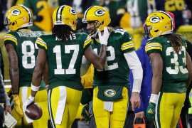 Packers WR Davante Adams (17) celebrates his touchdown reception with quarterback Aaron Rodgers (12) in the second quarter against Chicago. / 