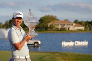 Matt Jones poses for a picture with the trophy after winning during The Honda Classic golf tournament. Mandatory Credit: Jasen Vinlove-USA TODAY Sports