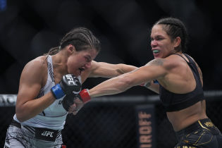Amanda Nunes moves in with a hit against Julianna Pena during UFC 269 at T-Mobile Arena. Mandatory Credit: Stephen R. Sylvanie-USA TODAY Sports.