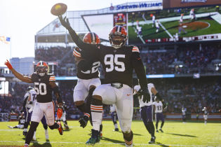 Cleveland Browns defensive end Myles Garrett (95) celebrates his touchdown against the Baltimore Ravens during the second quarter at FirstEnergy Stadium. Mandatory Credit: Scott Galvin-USA TODAY Sports.