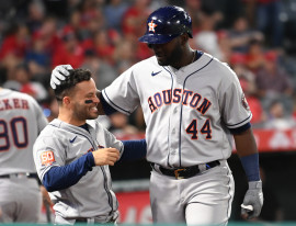 Houston Astros designated hitter Yordan Alvarez (44) is congratulated by second baseman Jose Altuve (27) after hitting a solo home run in the eighth inning against the Los Angeles Angels at Angel Stadium. Mandatory Credit: Jayne Kamin-Oncea-USA TODAY Sports.