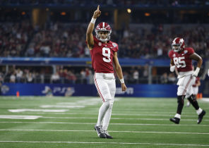 Alabama Crimson Tide quarterback Bryce Young (9) reacts after throwing a touchdown in the fourth quarter against the Cincinnati Bearcats during the 2021 Cotton Bowl college football CFP national semifinal game at AT&T Stadium.