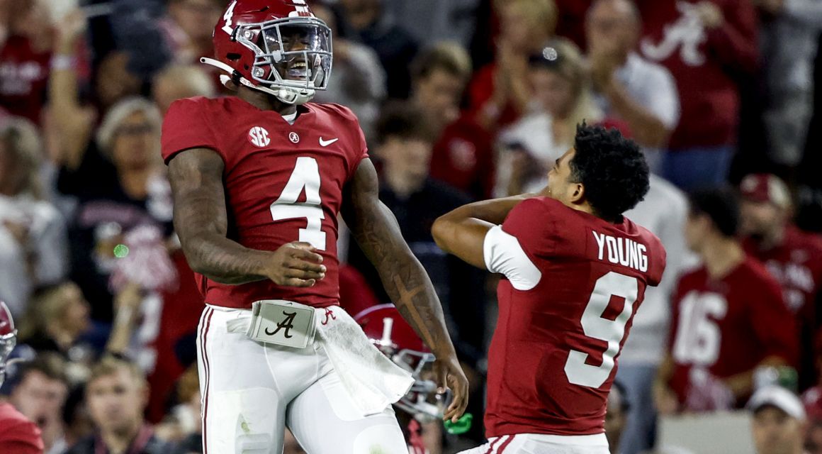 Alabama Crimson Tide quarterback Jalen Milroe (4) celebrates with quarterback Bryce Young (9) after throwing a touchdown pass against the Texas A&M Aggies during the first half at Bryant-Denny Stadium.